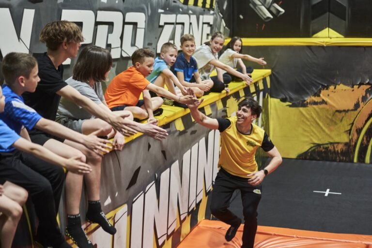 Kinder geben einem Jumpin Warrior Trainer High-Five bei einer Geburtstagsfeier